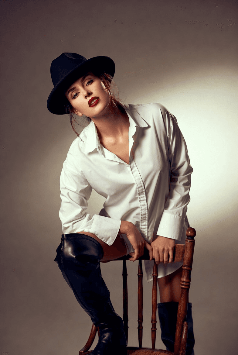 White shirt dress, thigh-high boots, fedora editorial portrait prompt